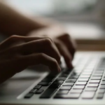 Hands typing on keyboard