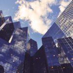 Low-angle shot of several skyscraper towers with reflective glass facades